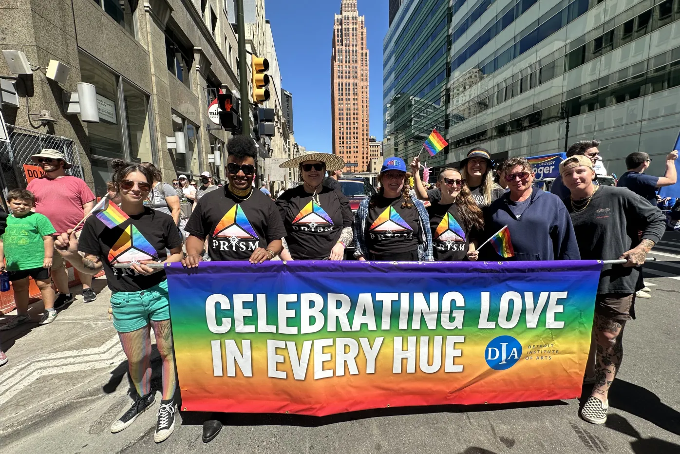 DIA staff and Prism members pose with their Pride parade banner