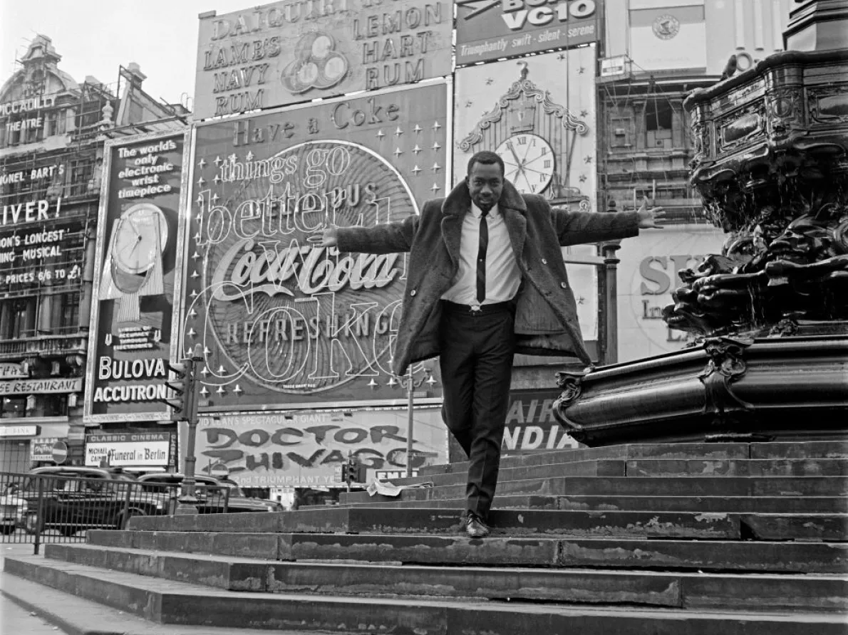 James Barnor (Ghana, b. 1929). Mike Eghan at Piccadilly Circus, London, 1967 (printed 2010–20). Gelatin silver print. Autograph, London.