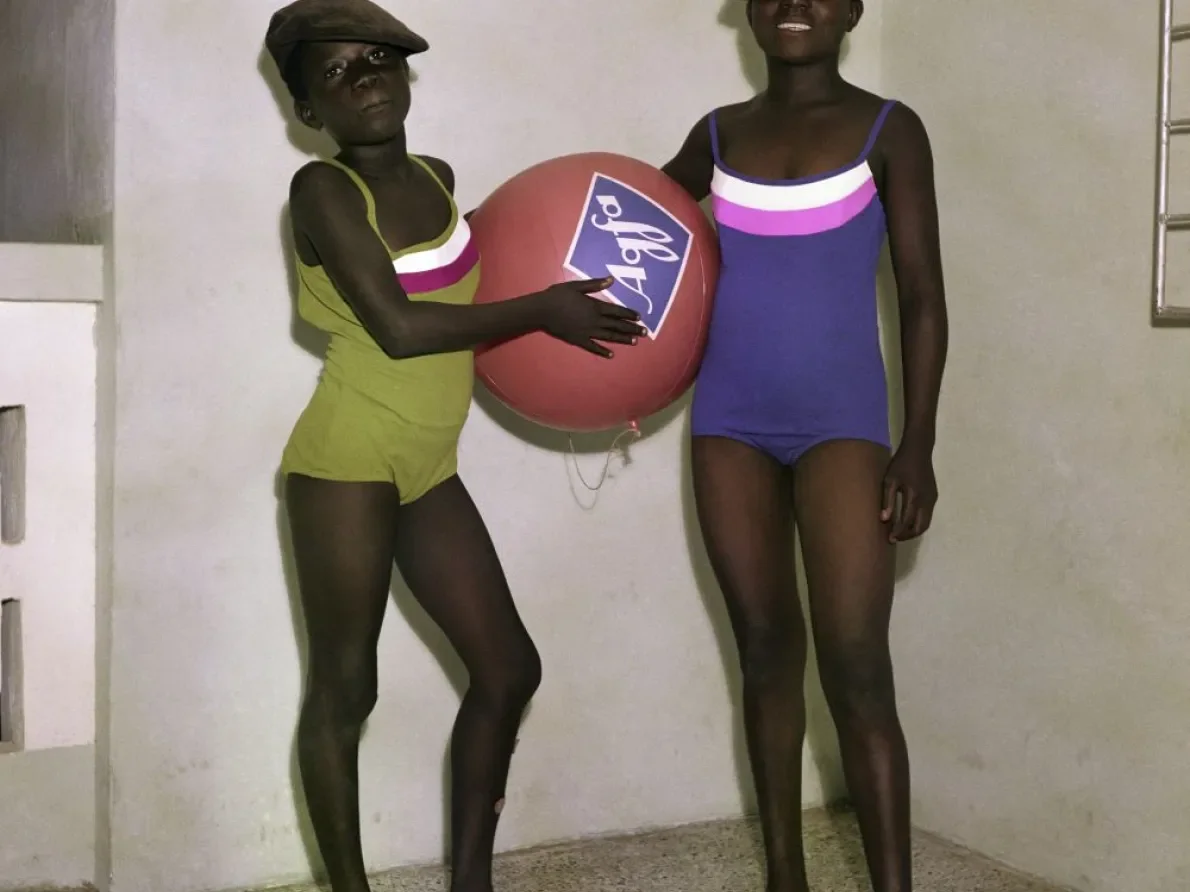 James Barnor (Ghana, b. 1929). Untitled #7 (Barnor’s daughters Mavis and Mary Barnor with an Agfa-Gevaert promotional ball), Accra, 1970 (printed 2010–20). Chromogenic print. Autograph, London.