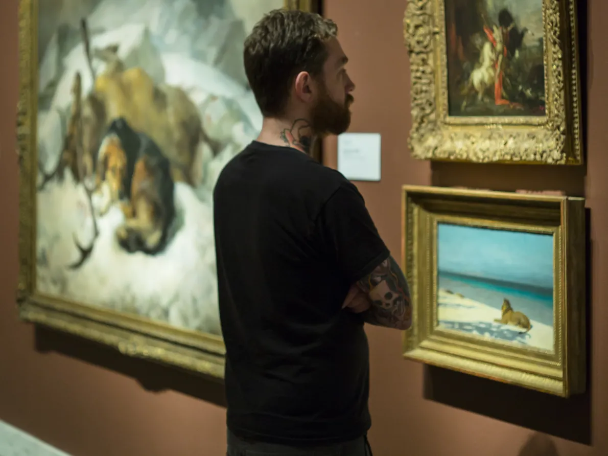 Person looking at art in a gallery in the Detroit Institute of Arts